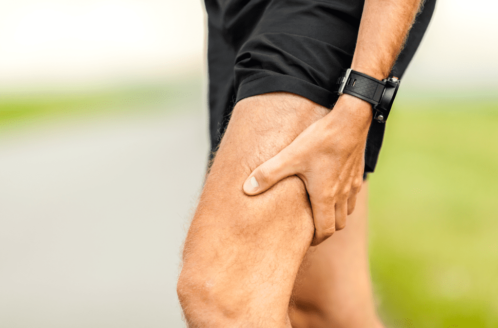 Man is rubbing his leg due to muscle soreness, which is a sea moss benefit for men