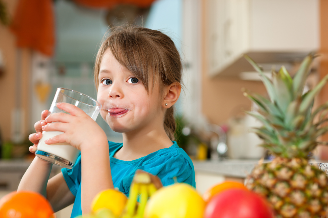 Girl Drinking liquid multivitamin for kids