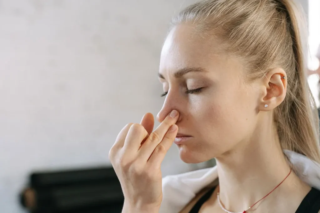 A woman doing yoga with the help of nose.  