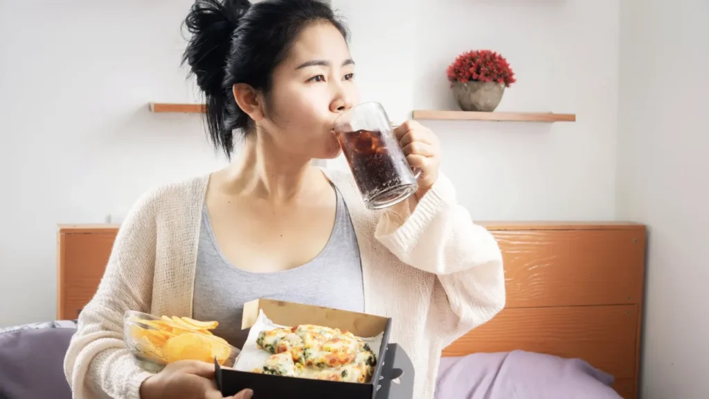 Lady having fast food. 